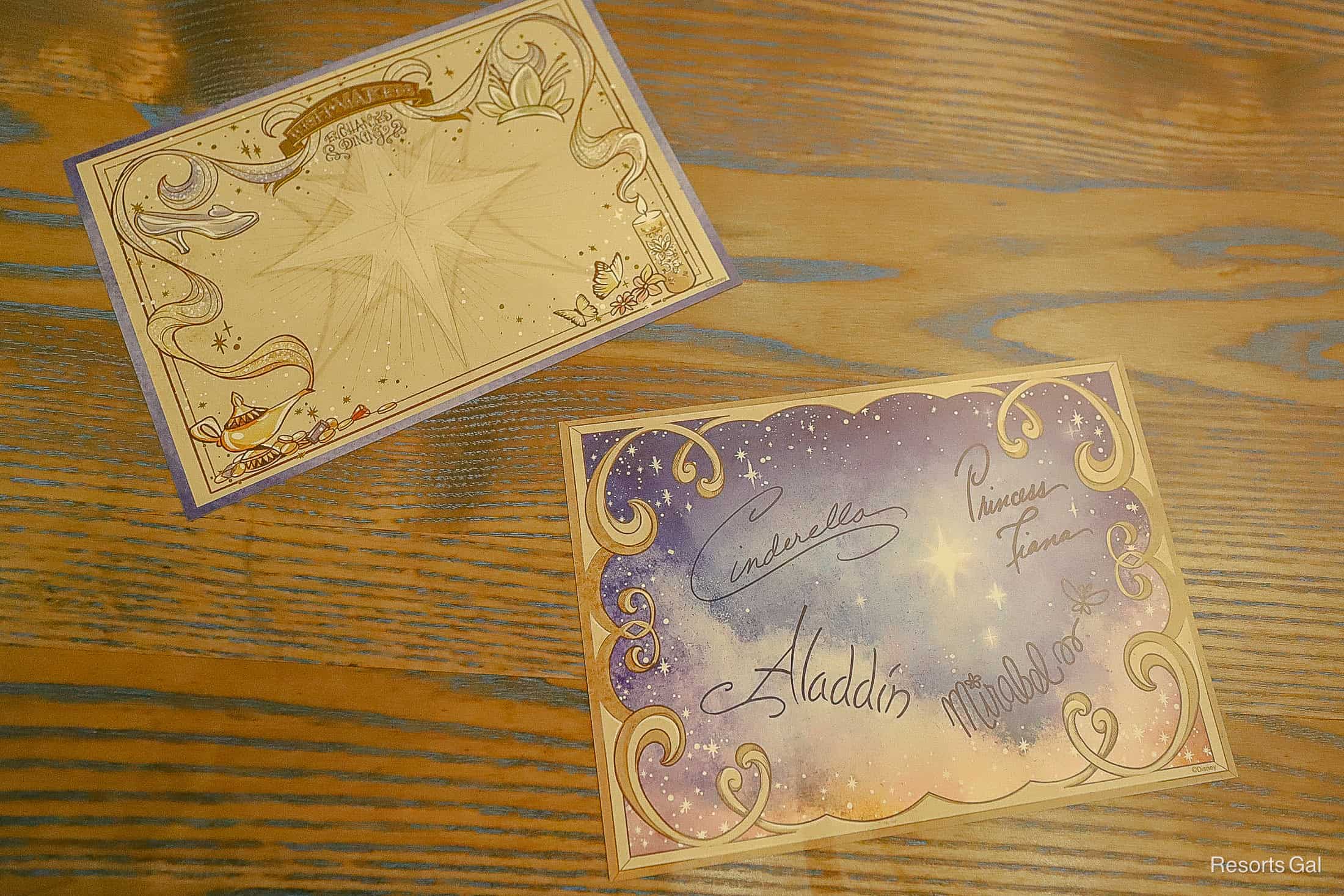 a character autograph card from 1900 Park Fare with Cinderella, Princess Tiana, Aladdin, and Mirabel's autographs