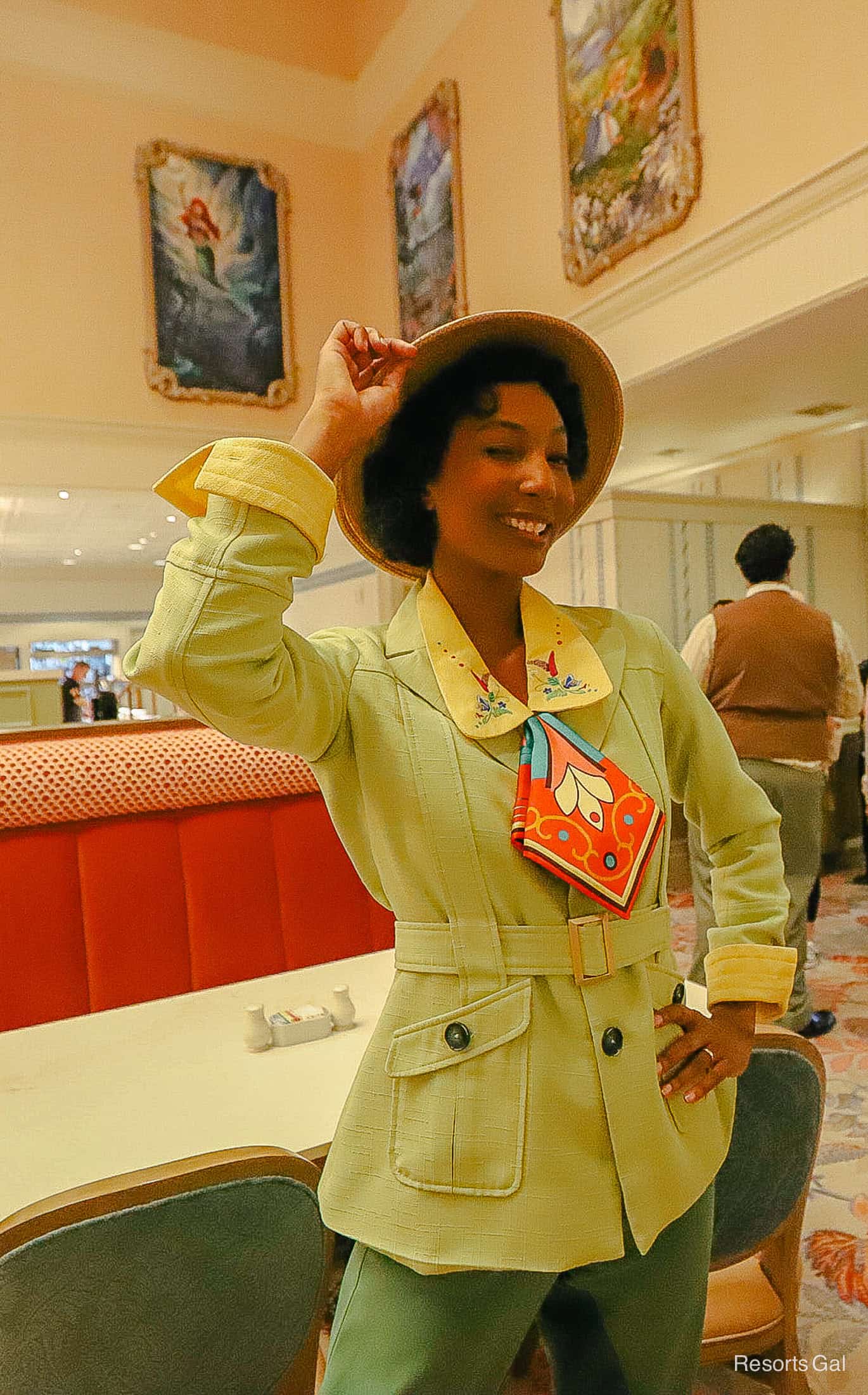 Tiana poses in her pant suit outfit with scarf at 1900 Park Fare breakfast with characters. 