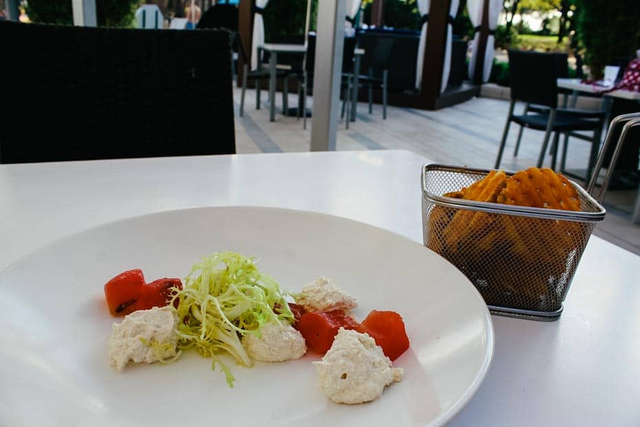 a plate with grilled watermelon, ricotta, and a side of sweet potato fries