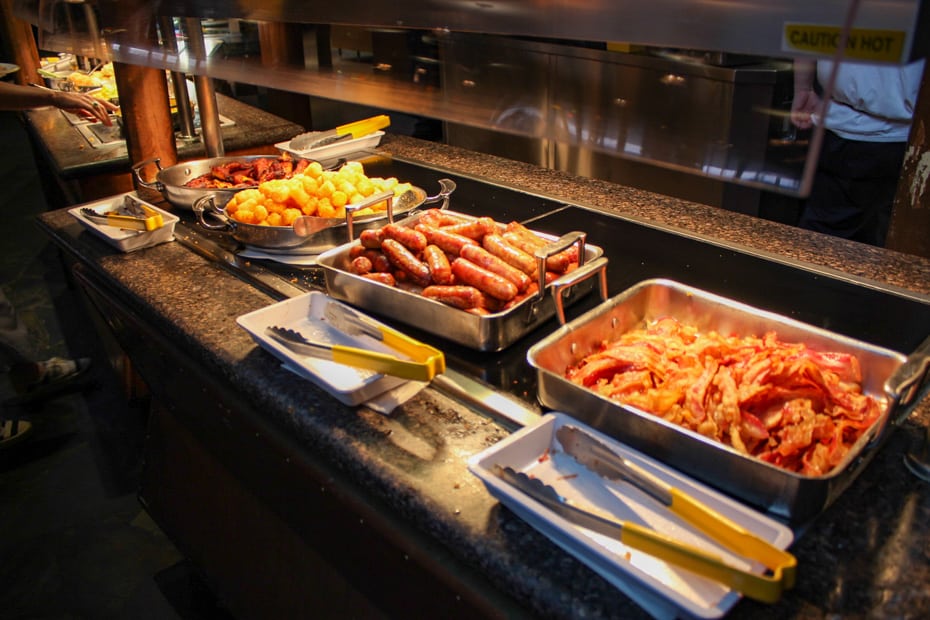 trays with bacon, sausage, potato barrels, and ham