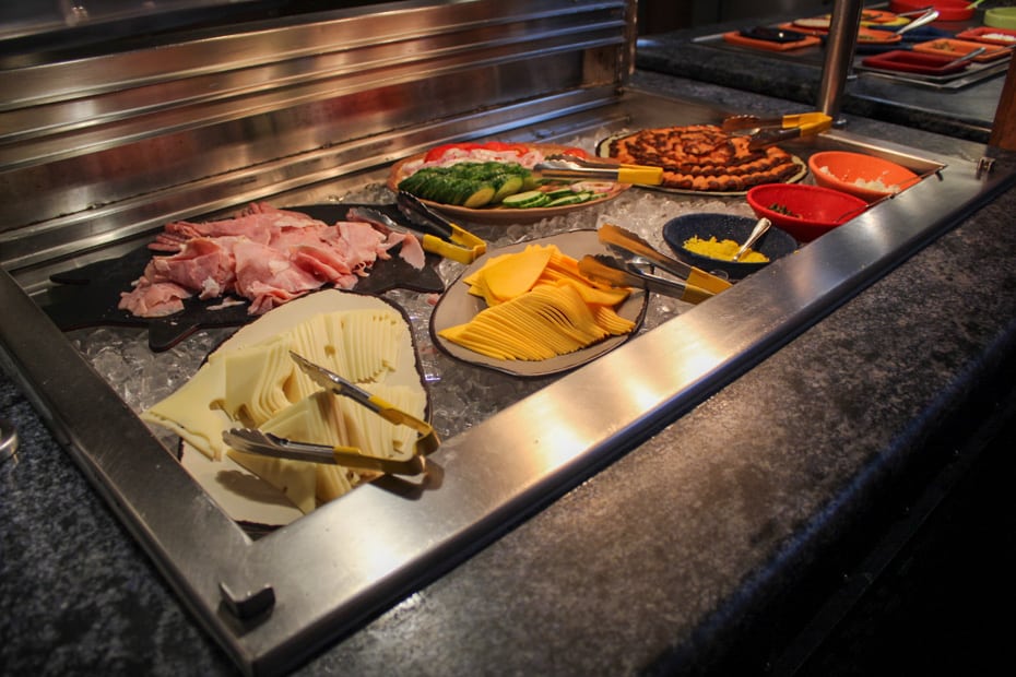 sliced meat, cheese, and smoked salmon with accompaniments
