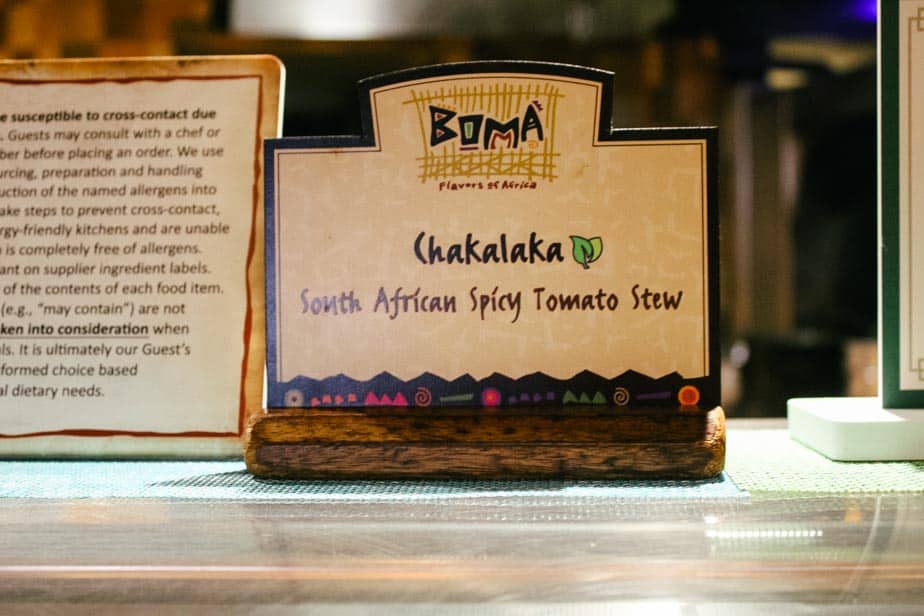 a green leaf on a sign denotes plant-based items at Boma, Flavors of Africa 