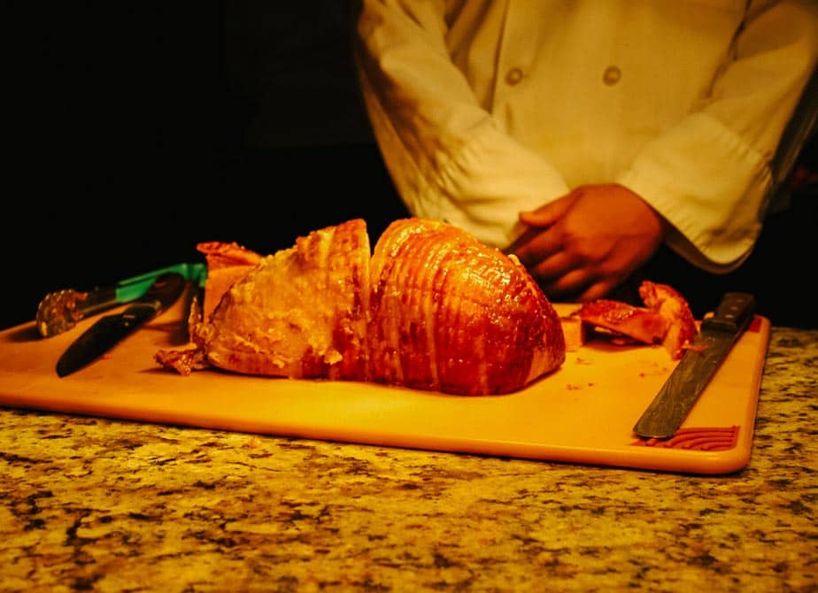 a chef carving ham 