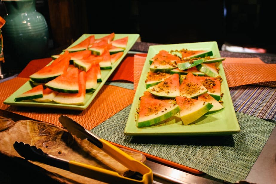 Watermelon slices, some topped with mint and pistachios 