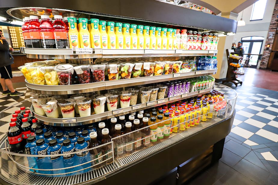 the opposite side of the case with yogurt parfaits, fresh fruit, and variety of milk, juice, and sports drinks 