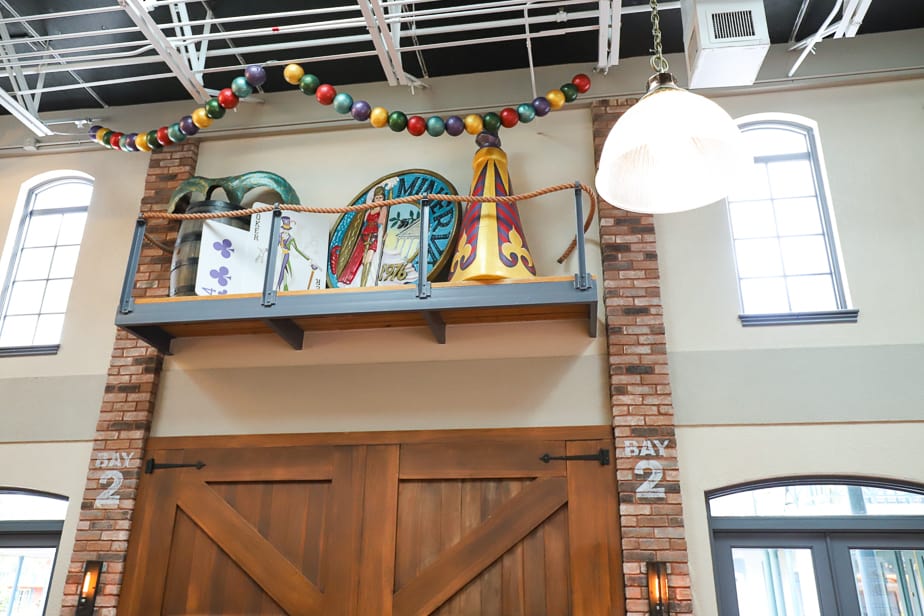 a shelf with parade props and other decorative elements inside Sassagoula Floatworks at Port Orleans French Quarter