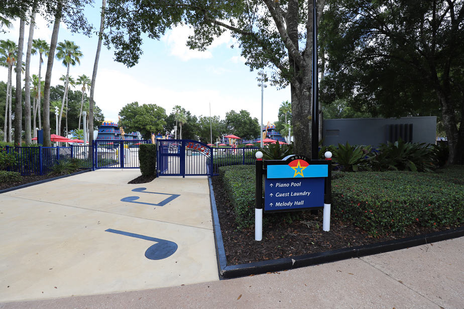 a sign that says Guest Laundry with a directional pointing near the Piano Pool at All-Star Music