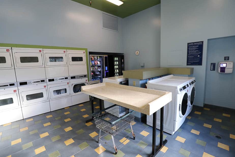 the interior of a laundry room at Port Orleans Riverside with washers, dryers, and folding tables 