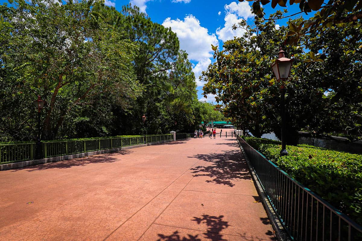 a sidewalk sloping down to Epcot's entrance