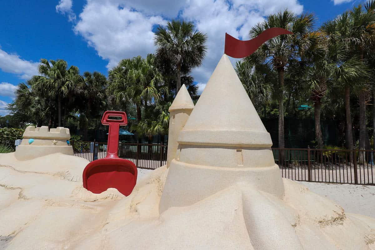 a fun faux sandcastle in a sand area for children by the pool