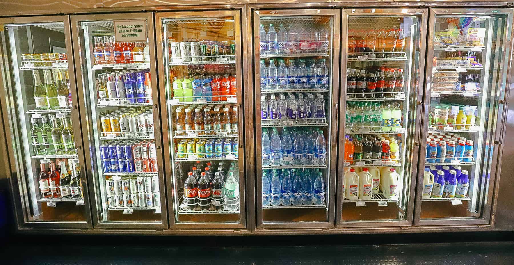 a refrigerated case with items like juice, sports drink, milk, and other beverages 