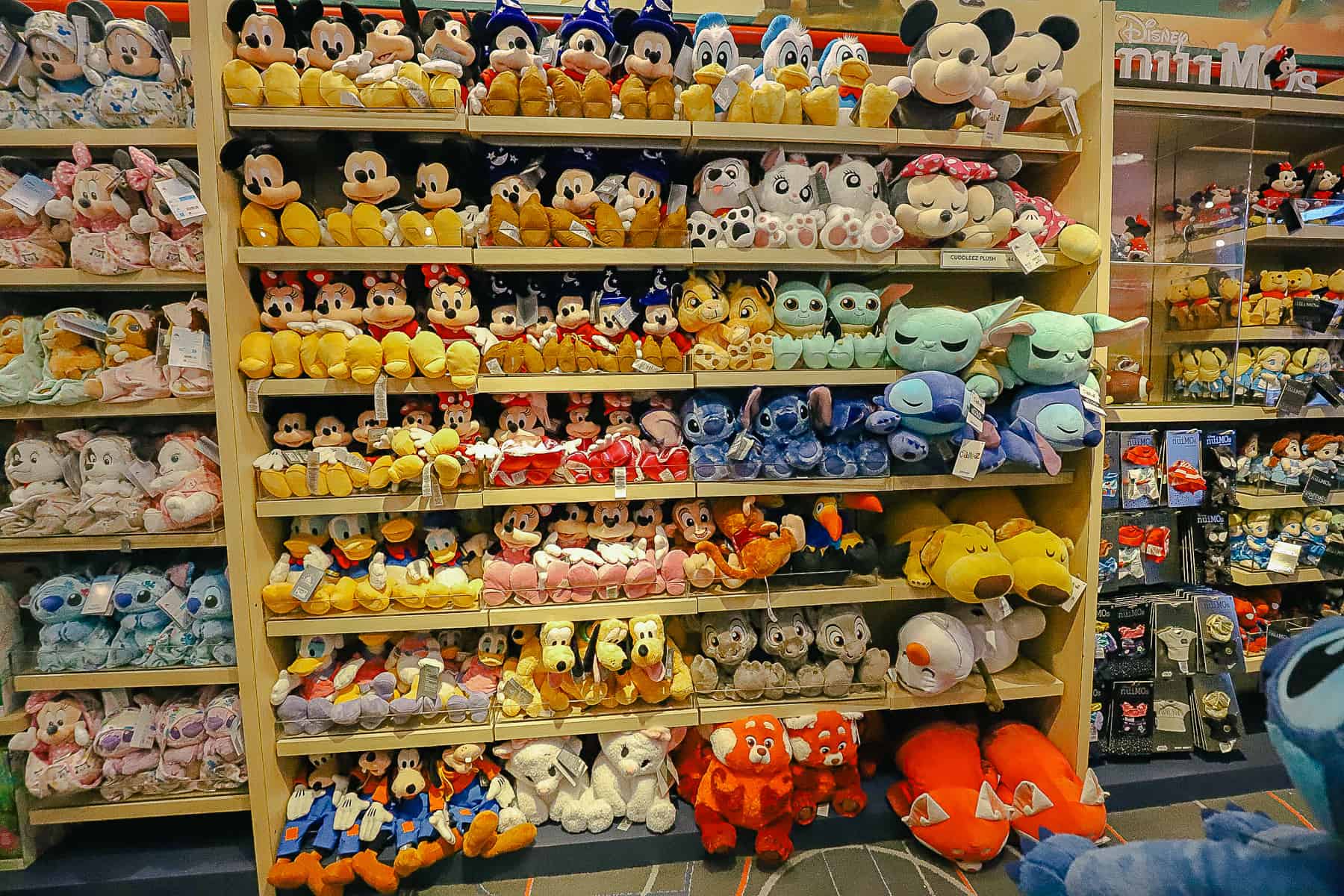 a wall of plush at Disney's Sport Goofy Gift Shop
