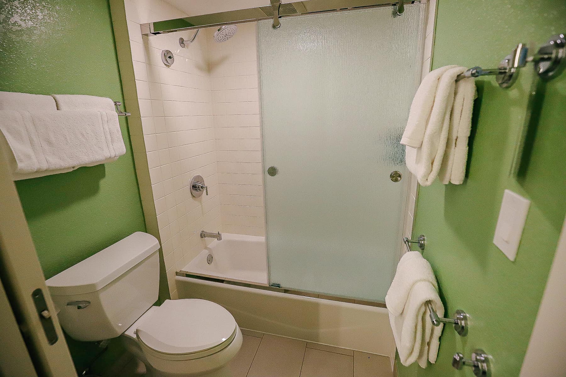 bathroom with tub and shower and glass shower doors