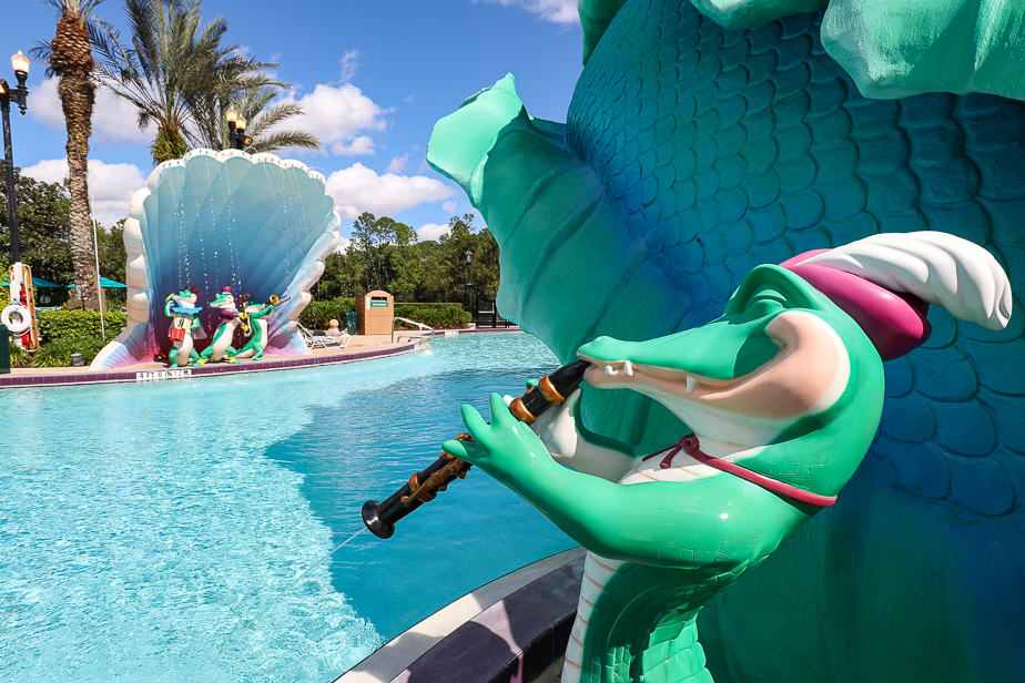 fun themed alligators playing jazz music near the pool 