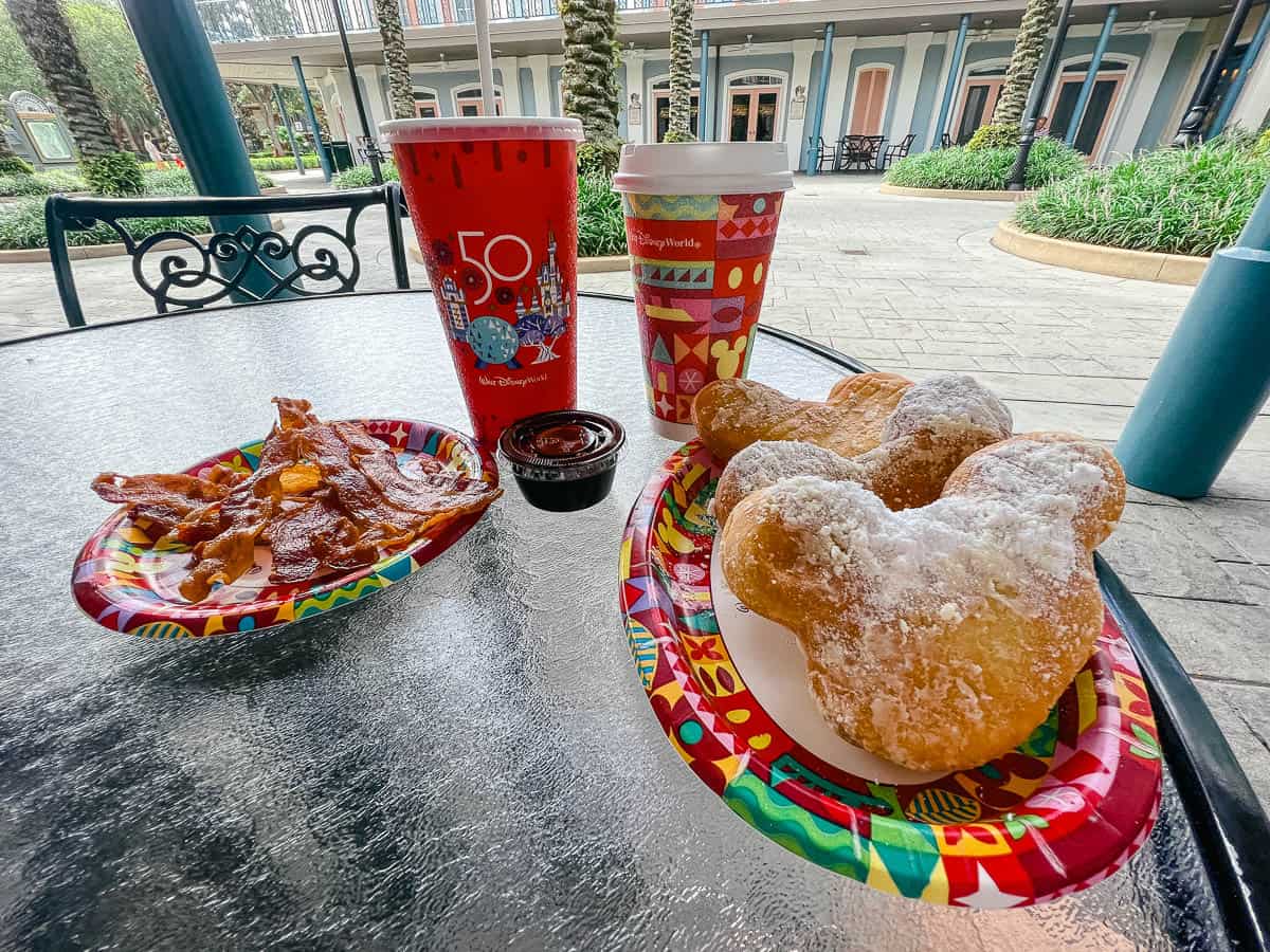 three Mickey shaped beignets with an order of bacon 