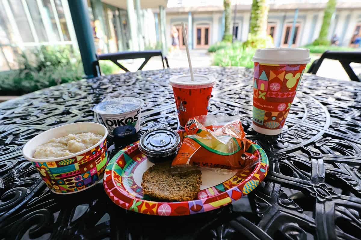 an outdoor iron table with a kids' meal of turkey sausage and oatmeal 