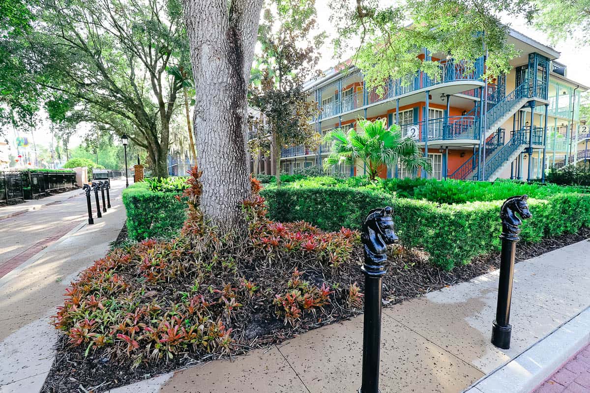 A scenic photo of Port Orleans French Quarter Resort with two iron horses. 