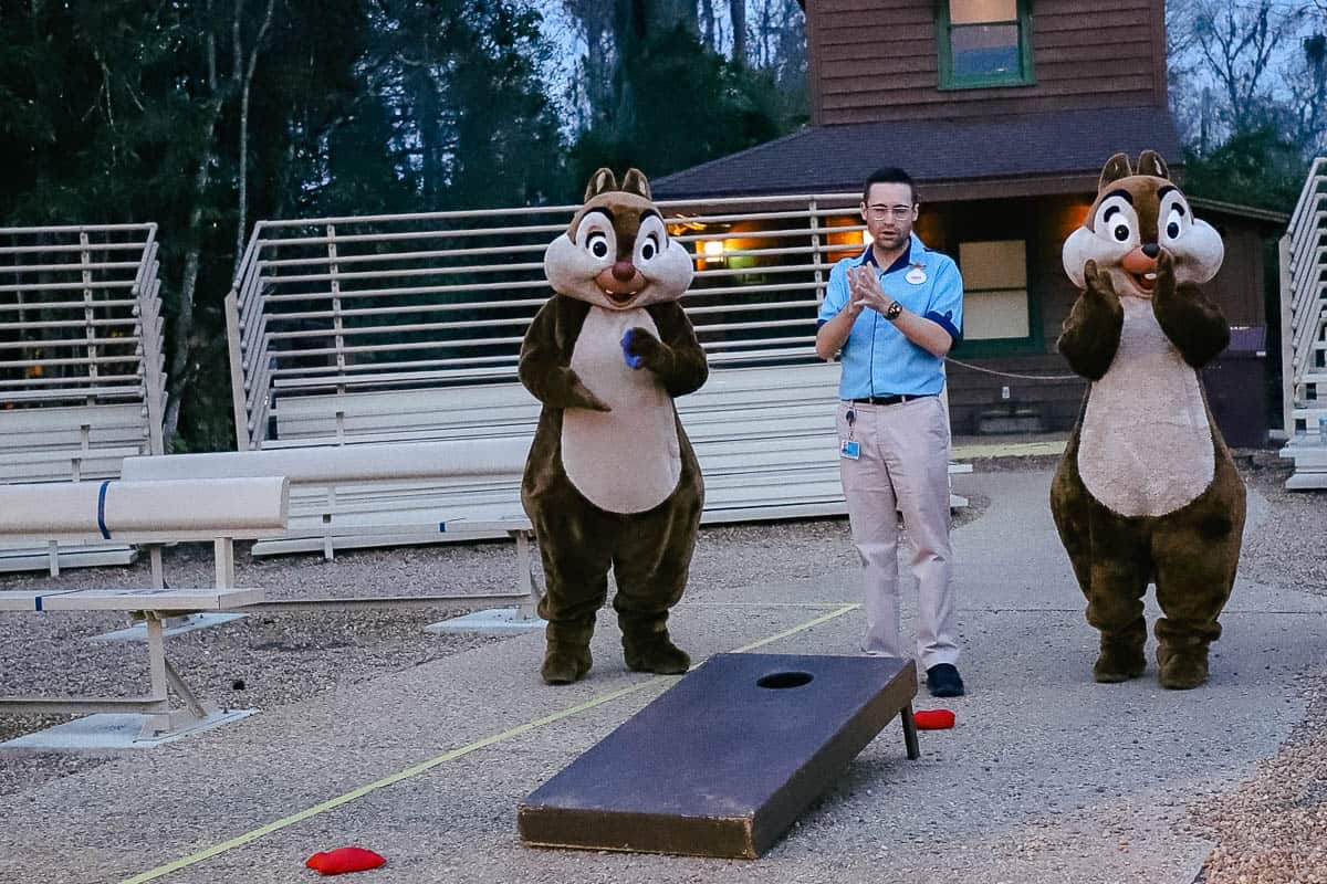 Chip and Dale playing cornhole with guests.