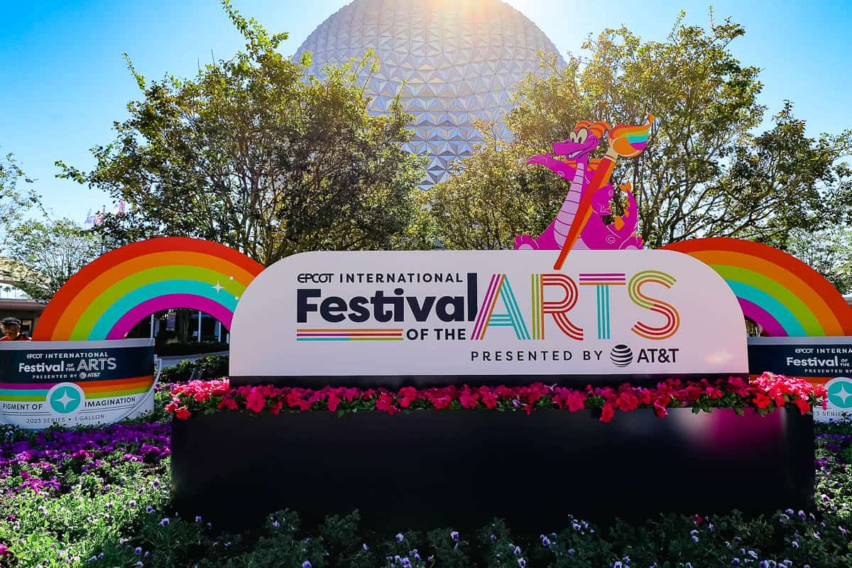 a display at the front of Epcot for the International Festival of the Arts with Figment holding a paintbrush 