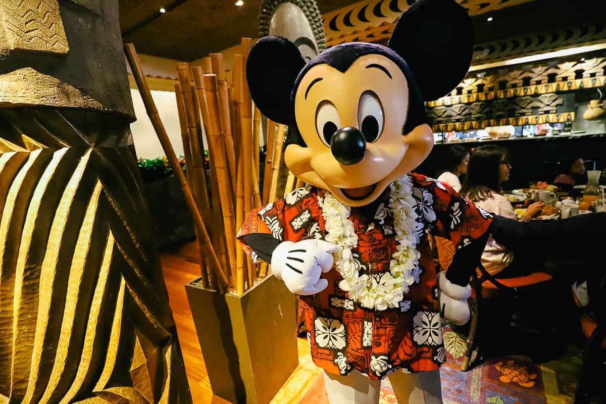 Mickey Mouse wearing a Hawaiian shirt. 