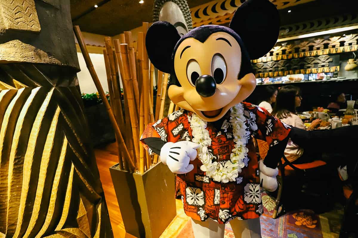 Mickey Mouse wearing a Hawaiian shirt.