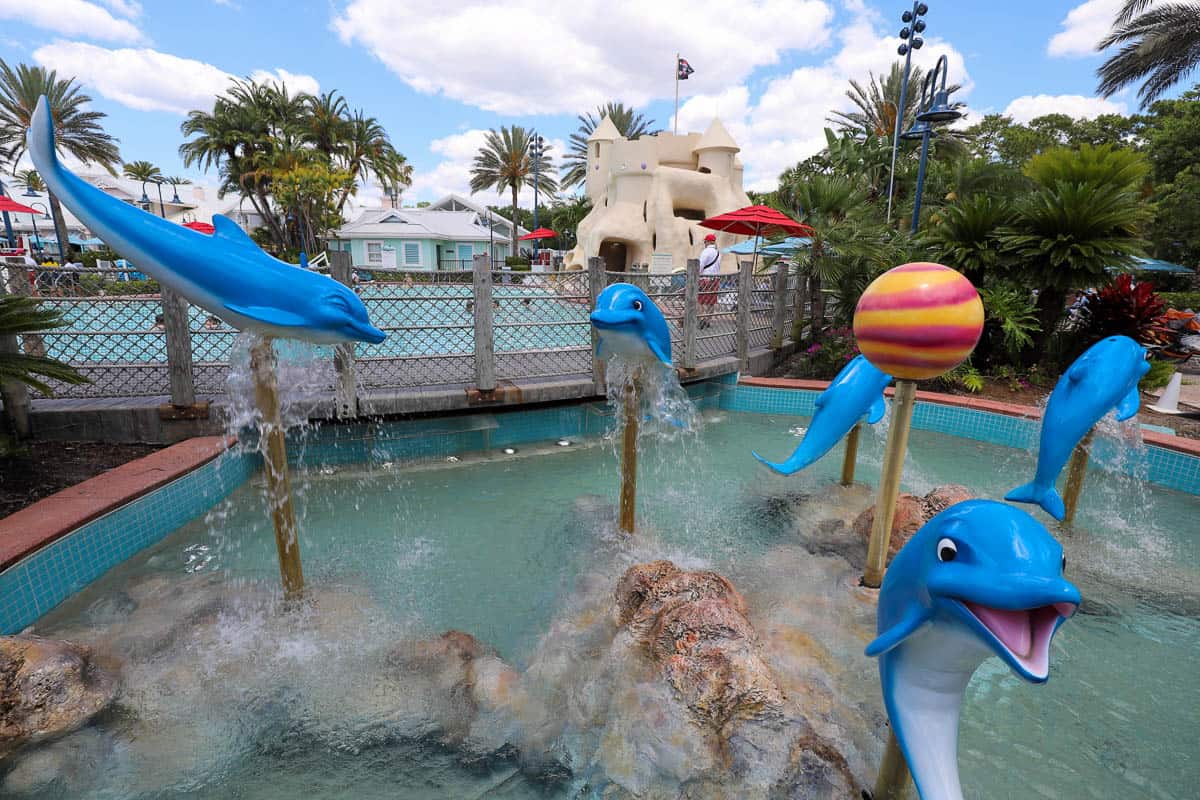 a water features with dolphins near the pool at Old Key West Disney