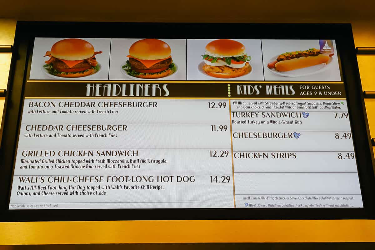 the menu board for the burger and sandwich section of World Premiere Food Court 