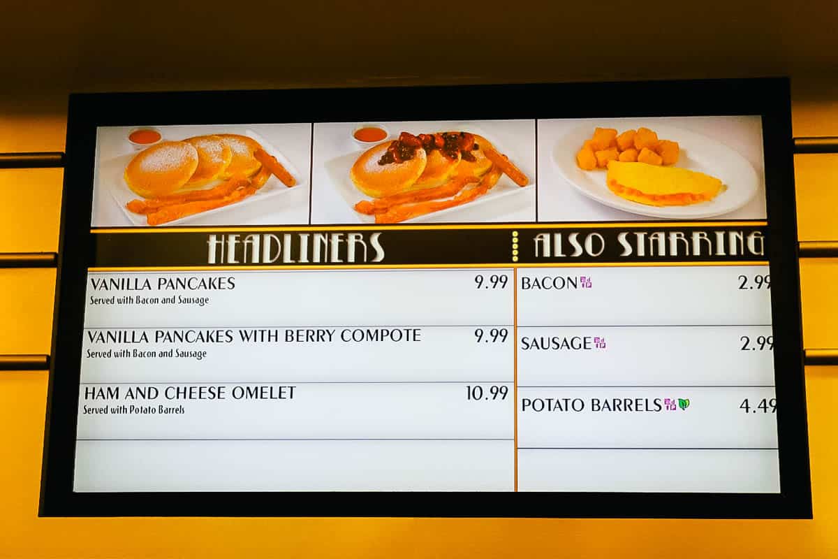 A menu board for World Premiere Food Court breakfast with pancakes and omelets. 