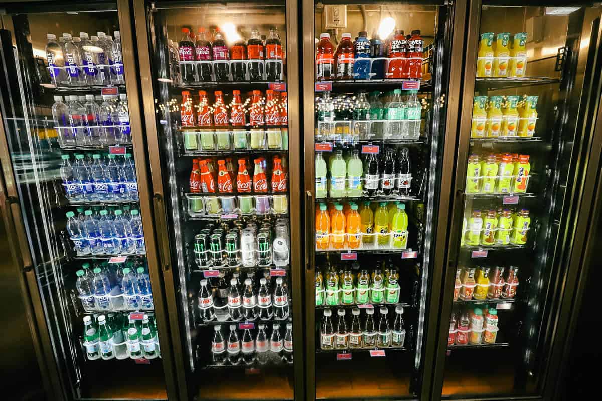 a refrigerated case with water, soda, juice, and milk at All-Star Movies Resort 