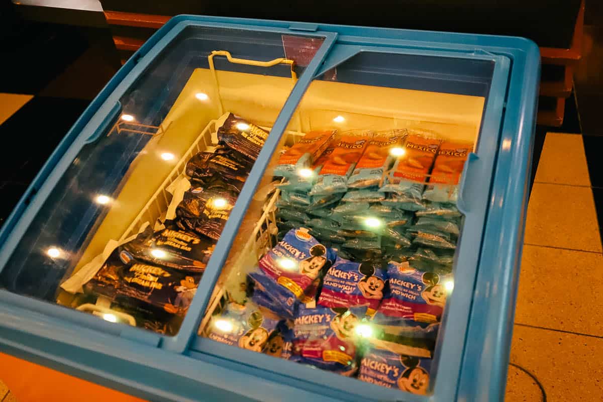 a freezer case with Mickey shaped ice cream treats and strawberry bars 