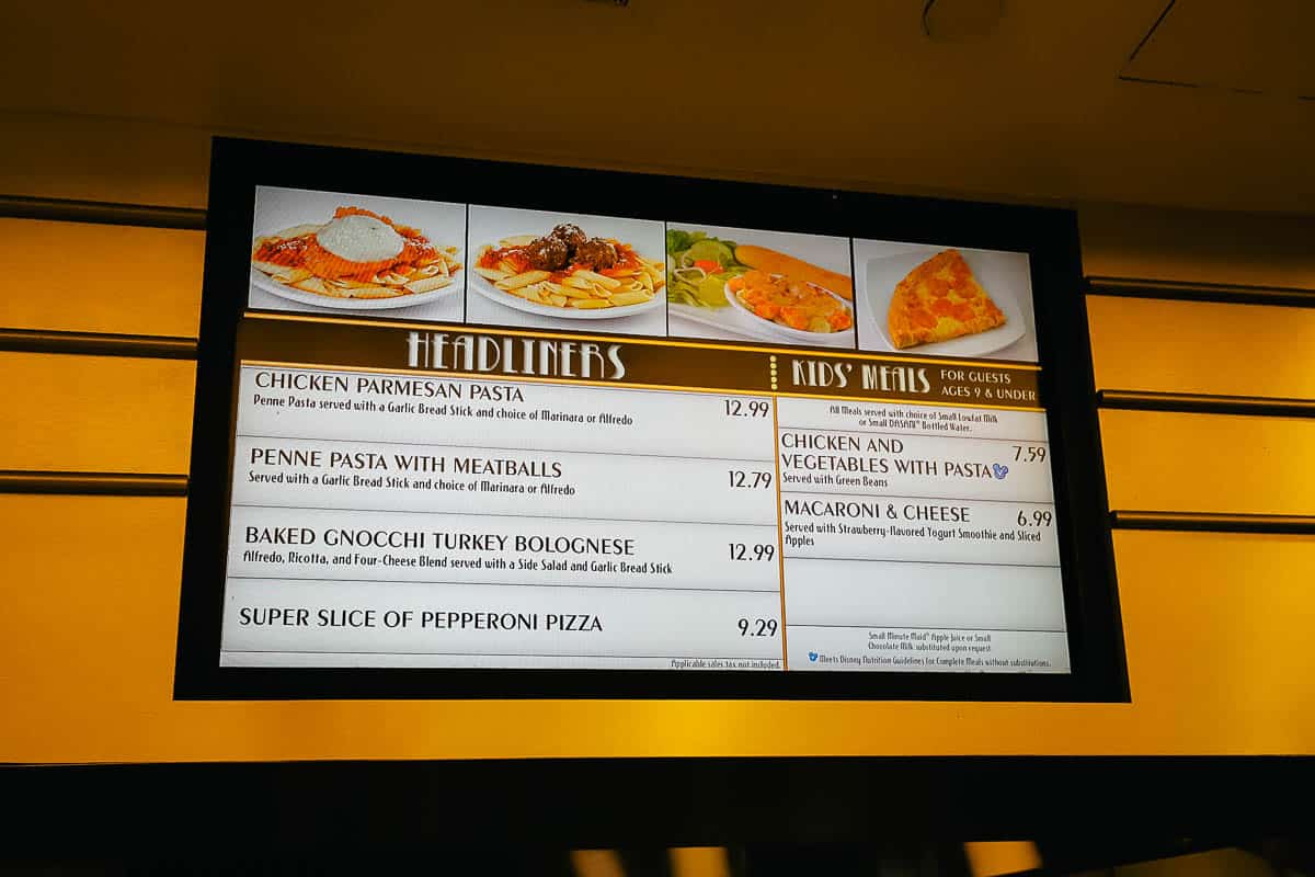 a menu board with Chicken Parmesan, Penne Pasta, Gnocchi, and other items at World Premiere Food Court 
