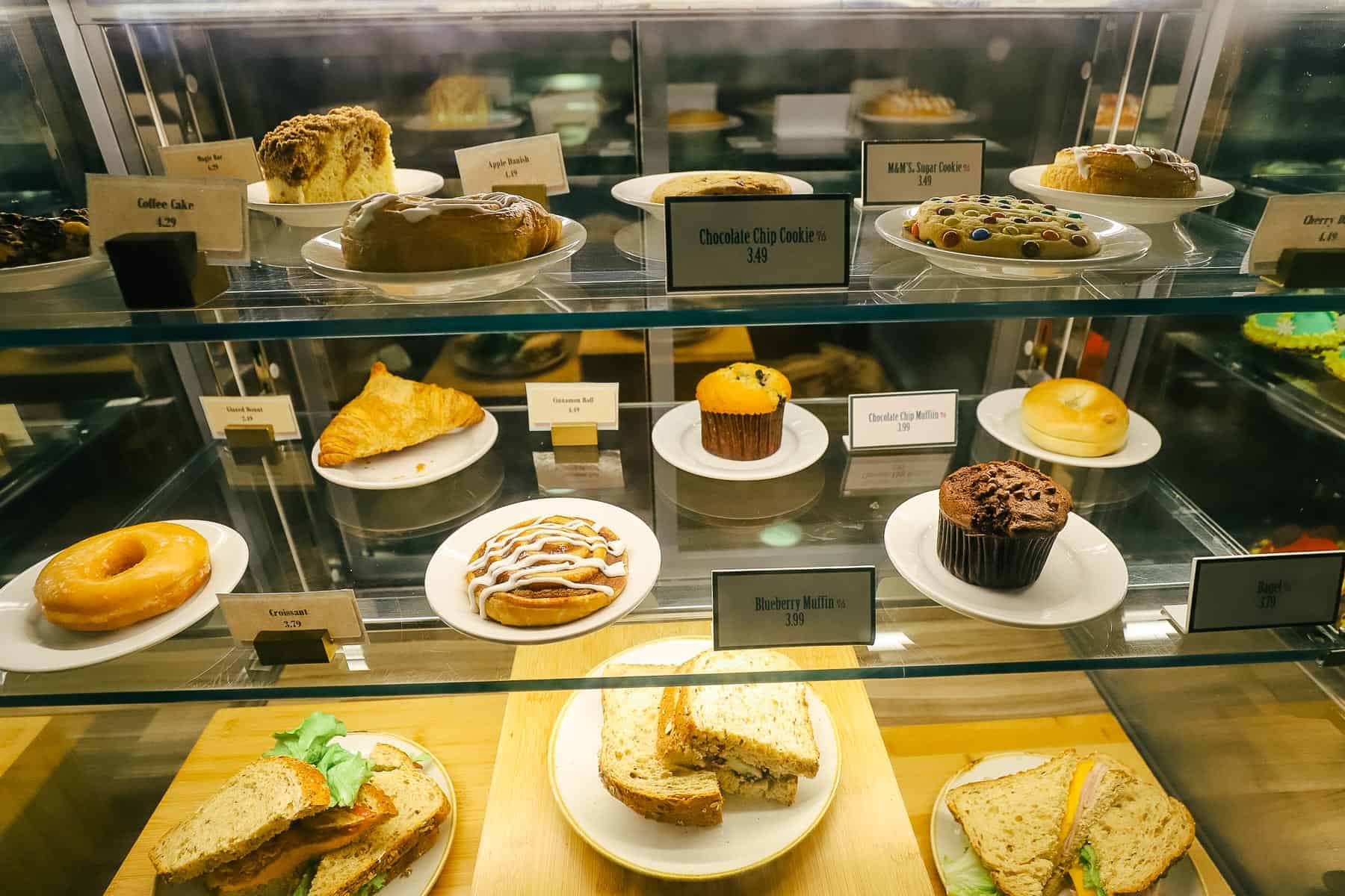 the dessert items on display like cookies, coffee cake, donuts, croissants, and muffins