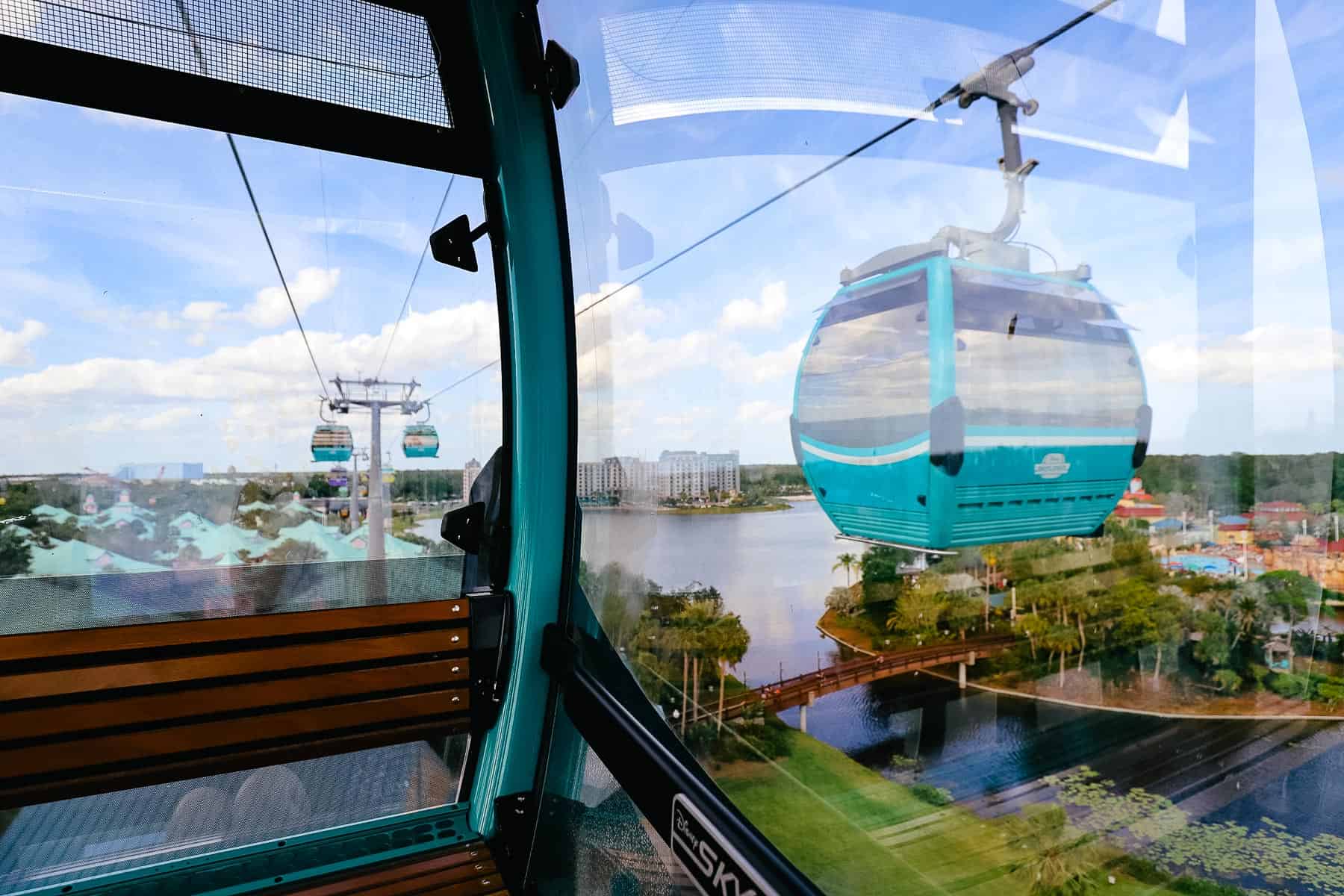 a Skyliner passing another Skyliner in the air at Disney World