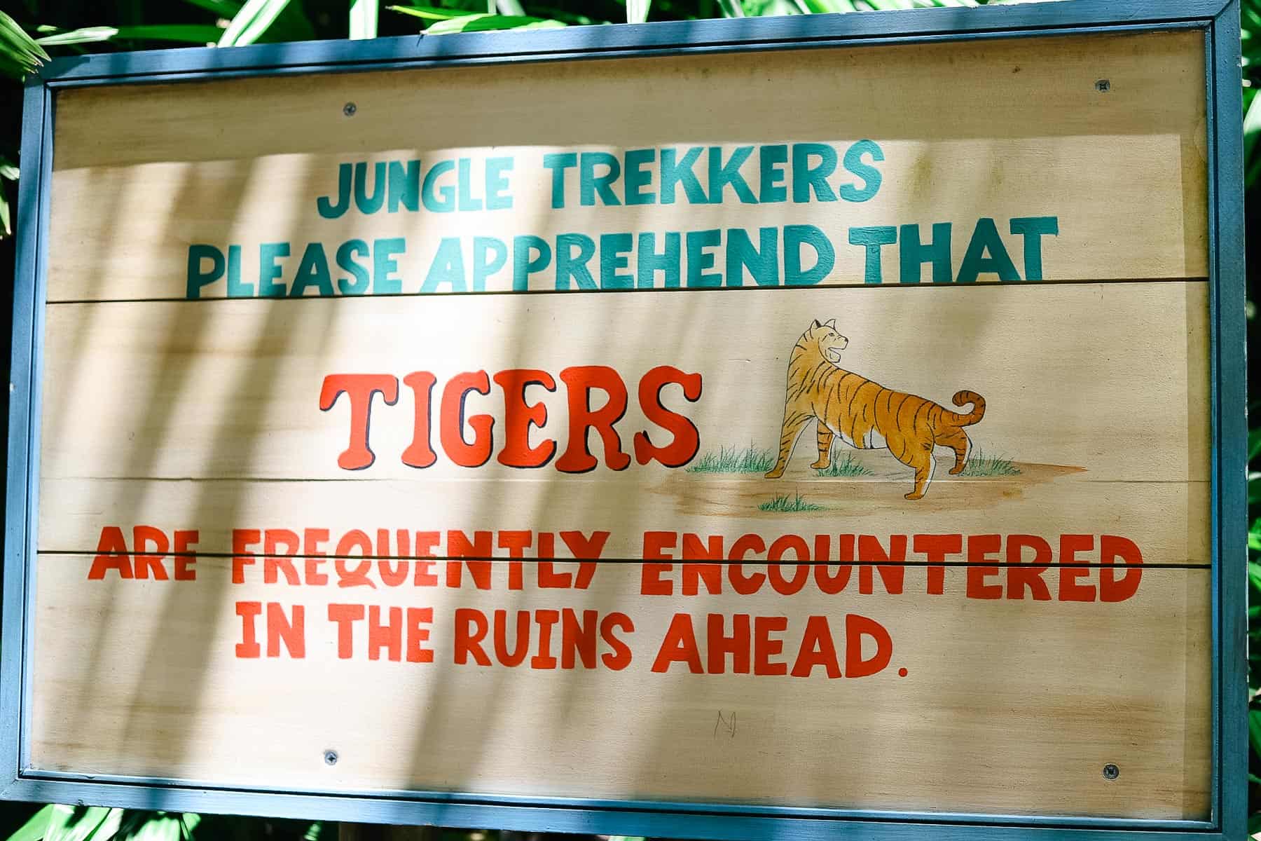 a sign that says Tigers are frequently encountered in the ruins ahead on the Maharajah Jungle Trek 