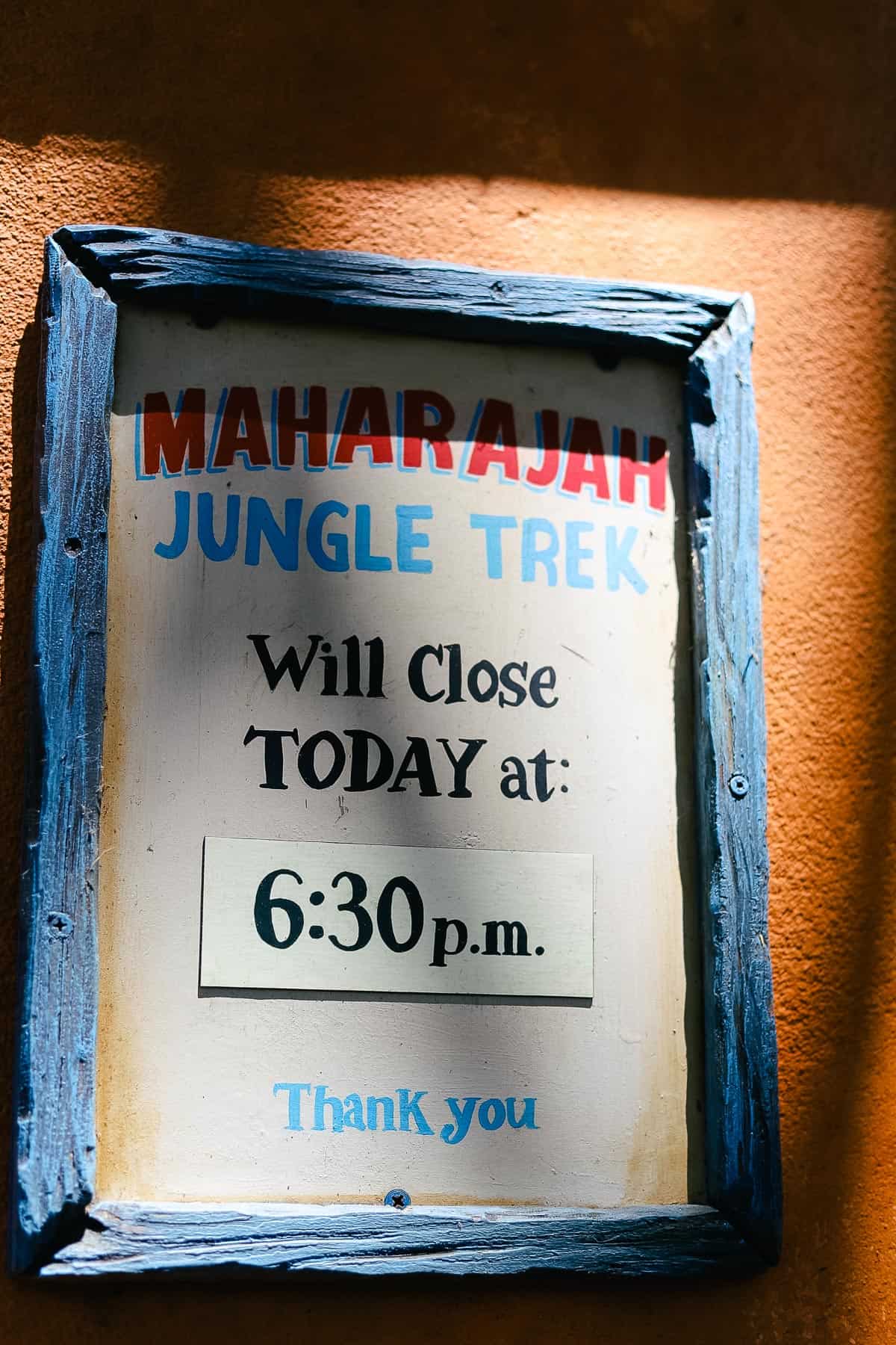 a sign that tells what time the Maharajah Jungle Trek closes each day 