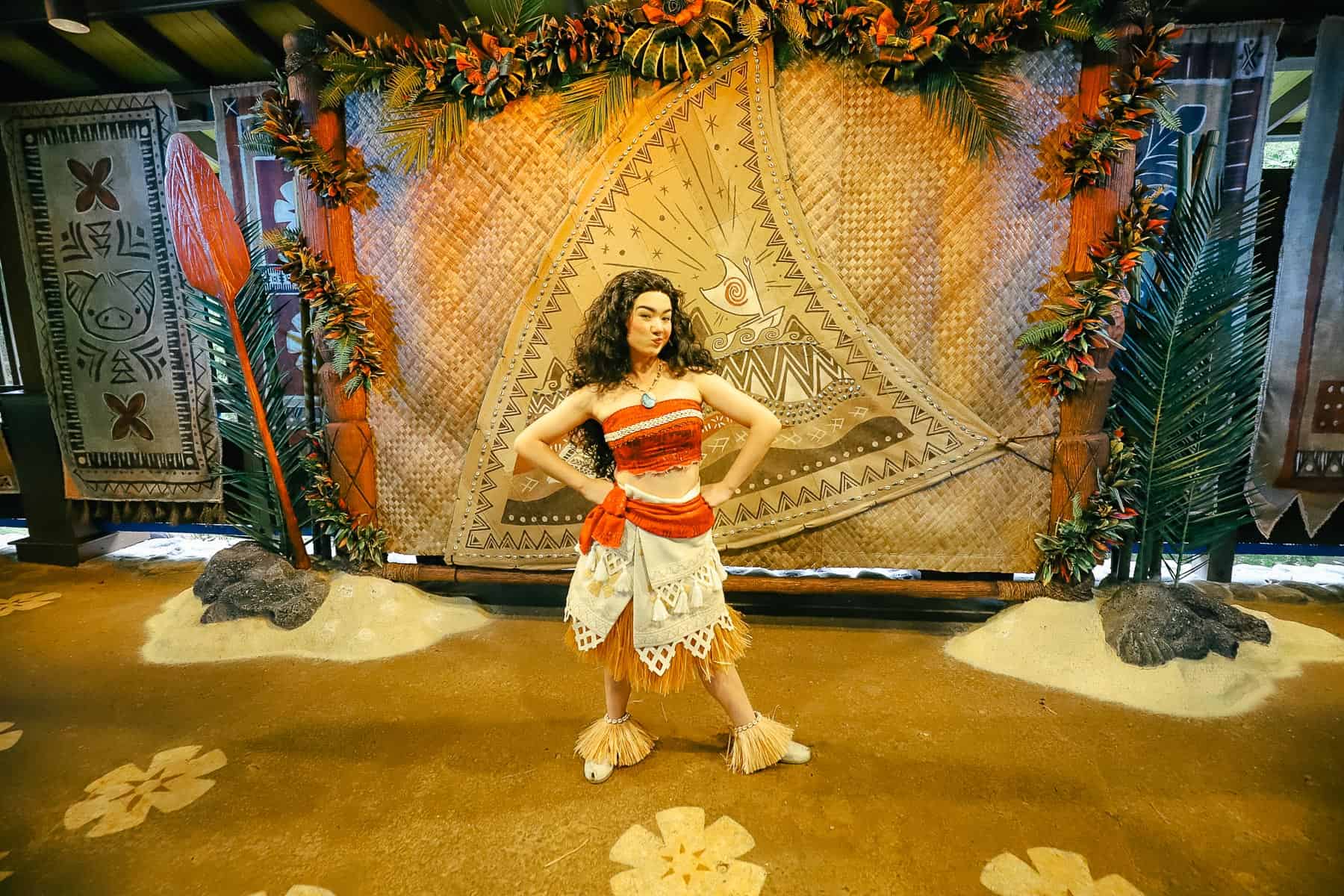 Moana poses with her hands on hips for a photo.