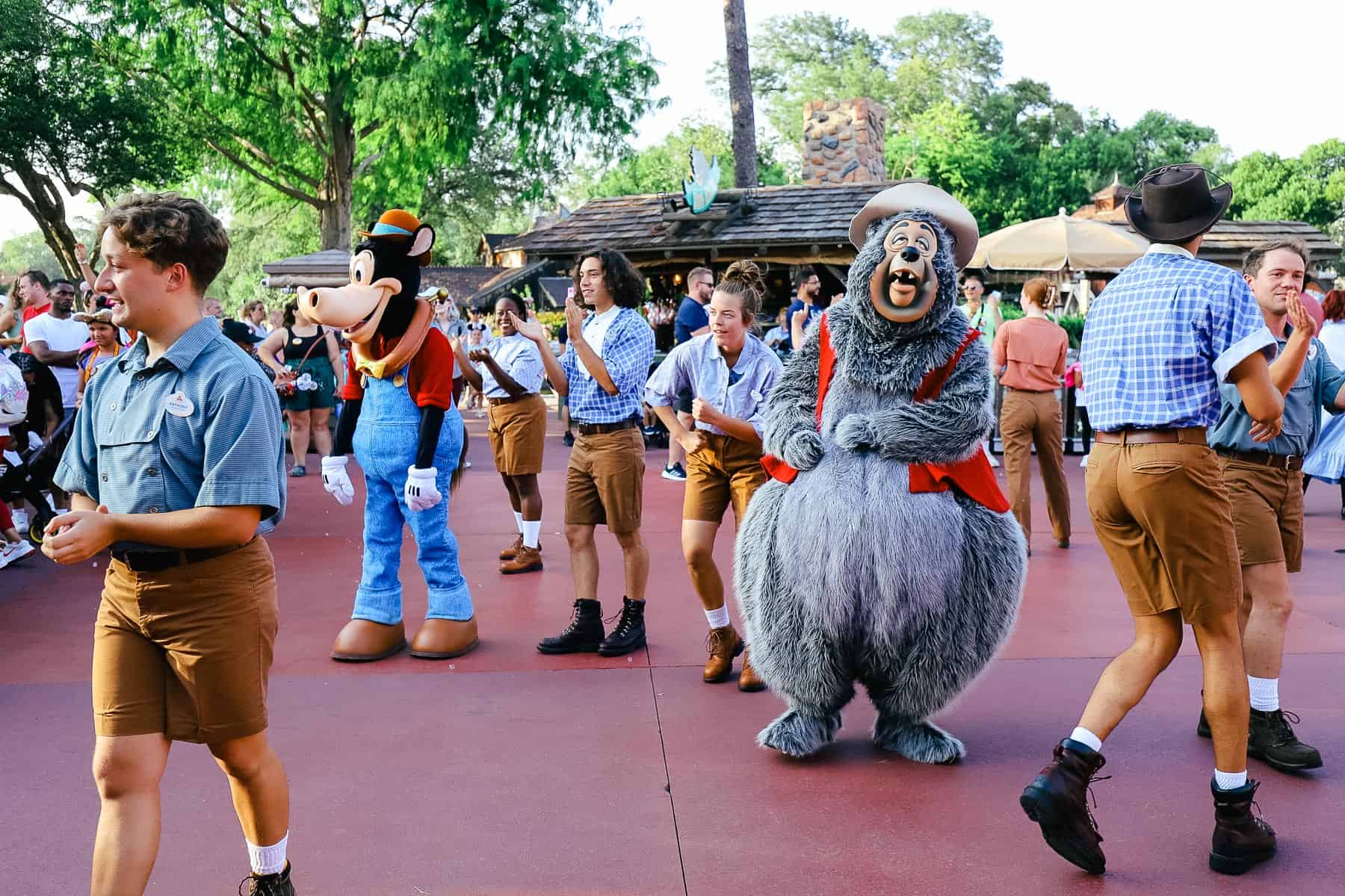 Cast members dance along with characters in the Frontierland Hoedown