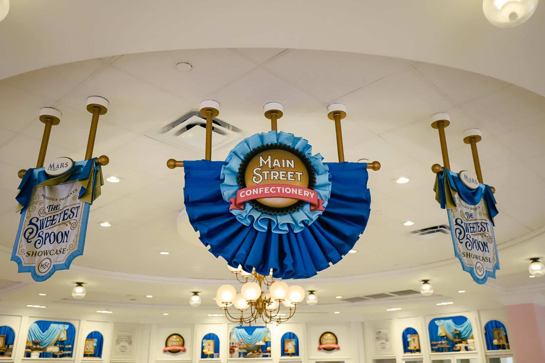 banners hanging over The Sweetest Spoon showcase in the center of the Main Street Confectionery
