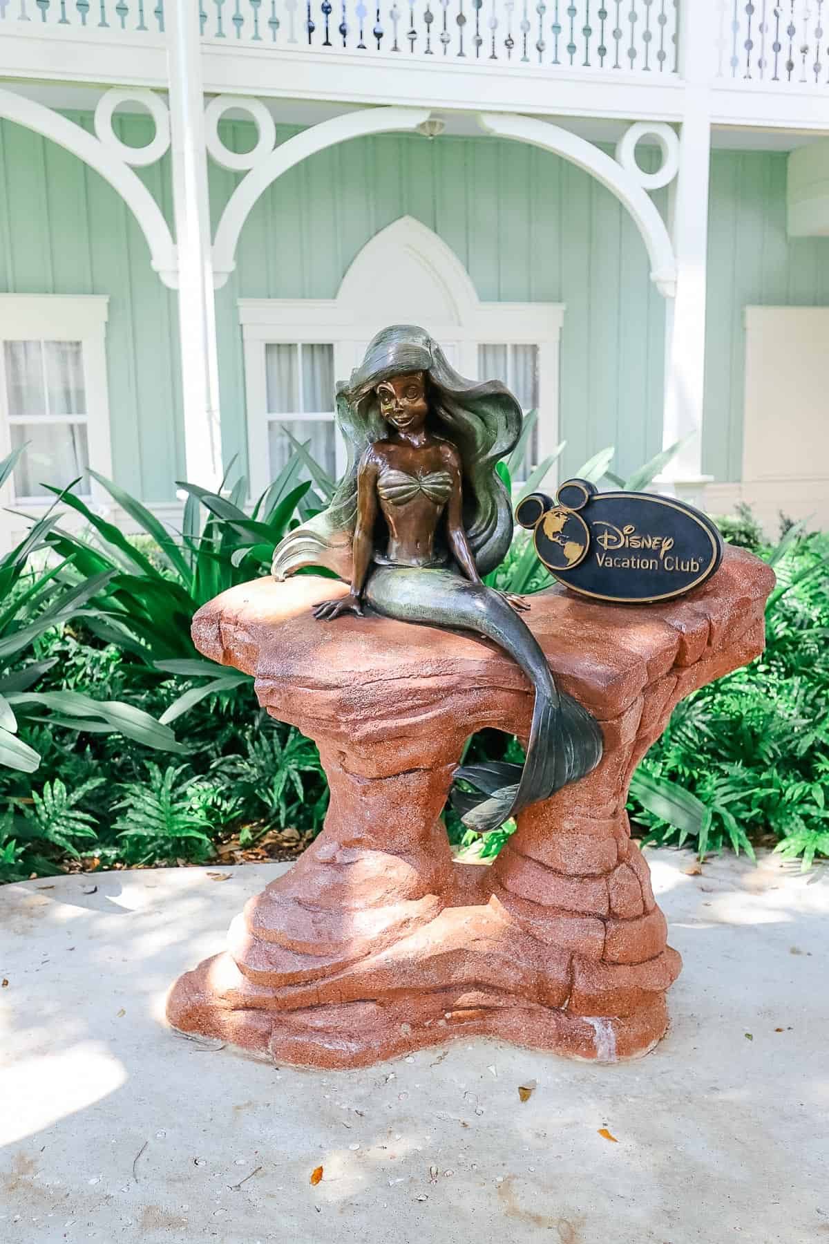 A statue of Ariels sits outside this Disney Villa Resort. 