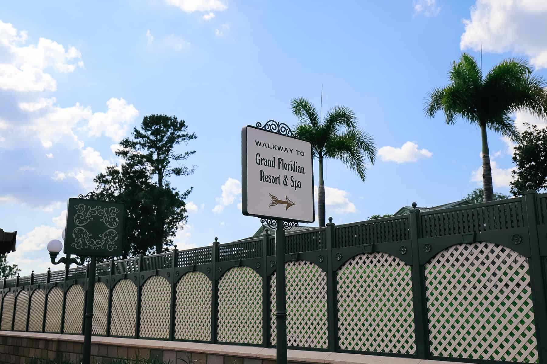 a directional with an arrow that says walkway to Grand Floridian Resort and Spa 