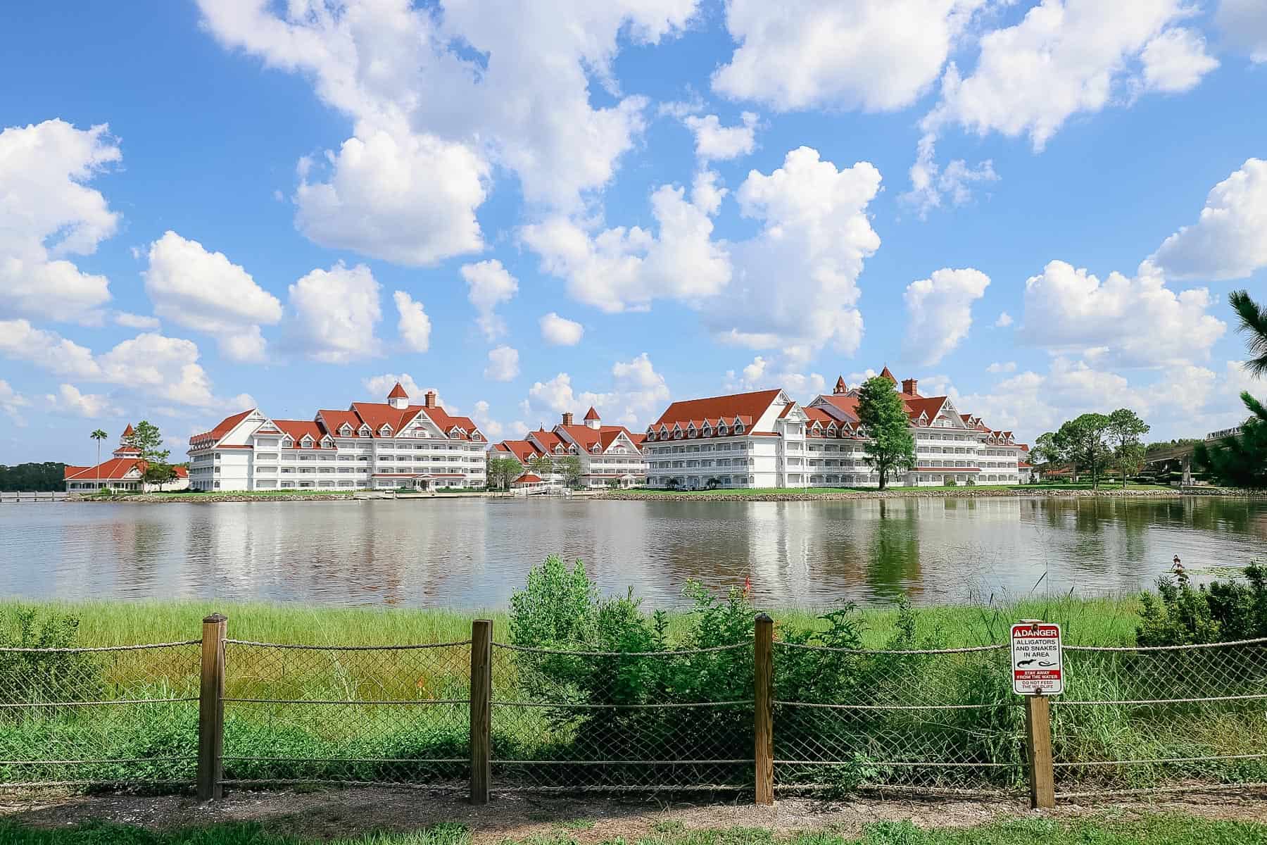 a photo of Grand Floridian with a sign in front of it warning of potentially dangerous wildlife 