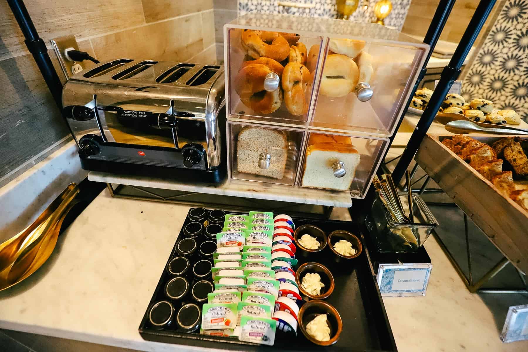 Bread box with bagels, sliced bread, and a toaster oven in the Chronos Club 
