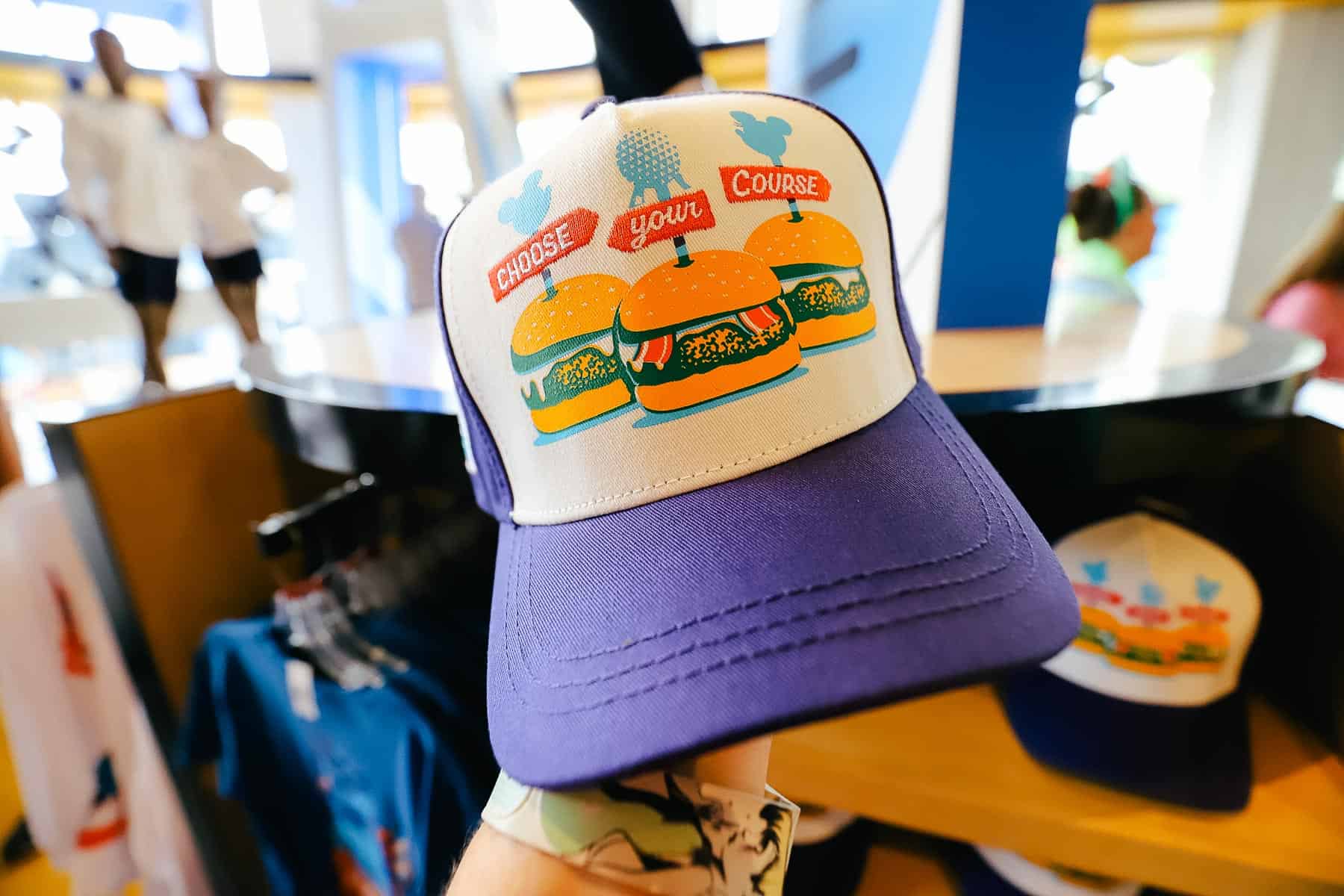 A ball cap with three burgers that says choose your course. 
