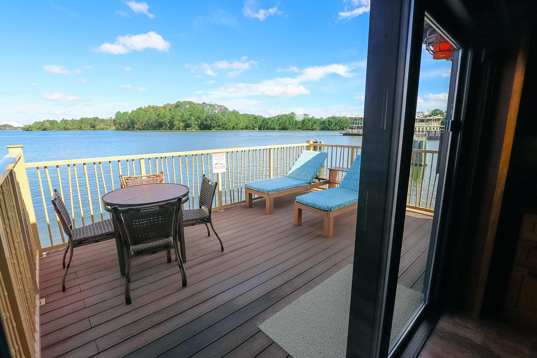 back deck with table and chairs and loungers 