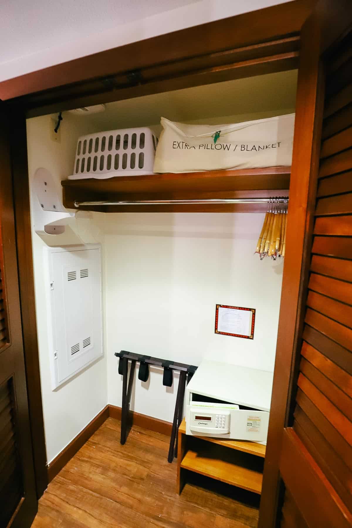 closet with laundry basket, extra pillow, iron, luggage rack, and in-room safe 