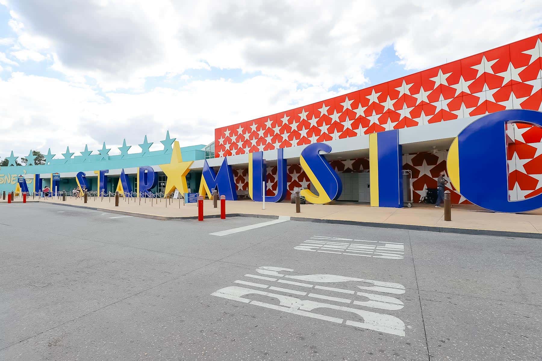 Bus Stop at Disney's All-Star Music with the resort's signage in the background. 