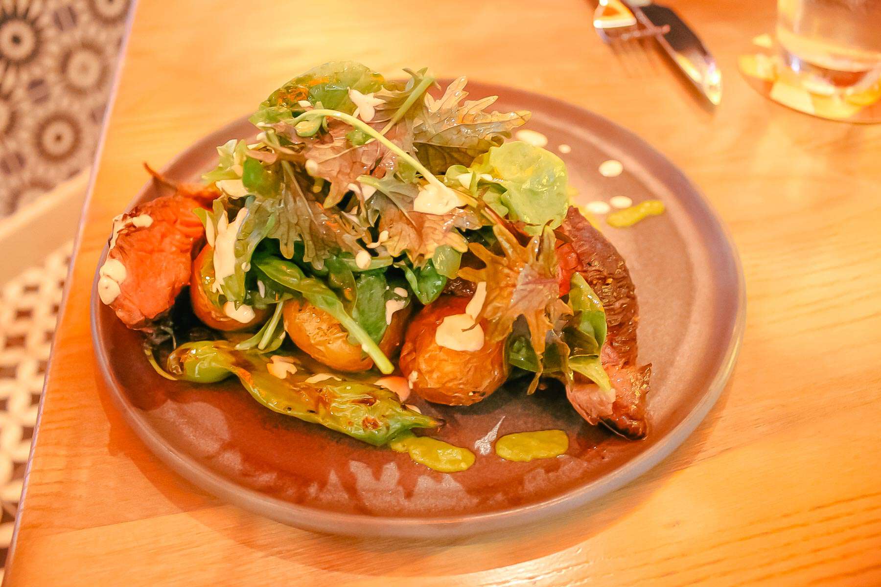 Marinated Hanger Steak-Potatoes, Salsa Verde, Greens and blistered Peppers
