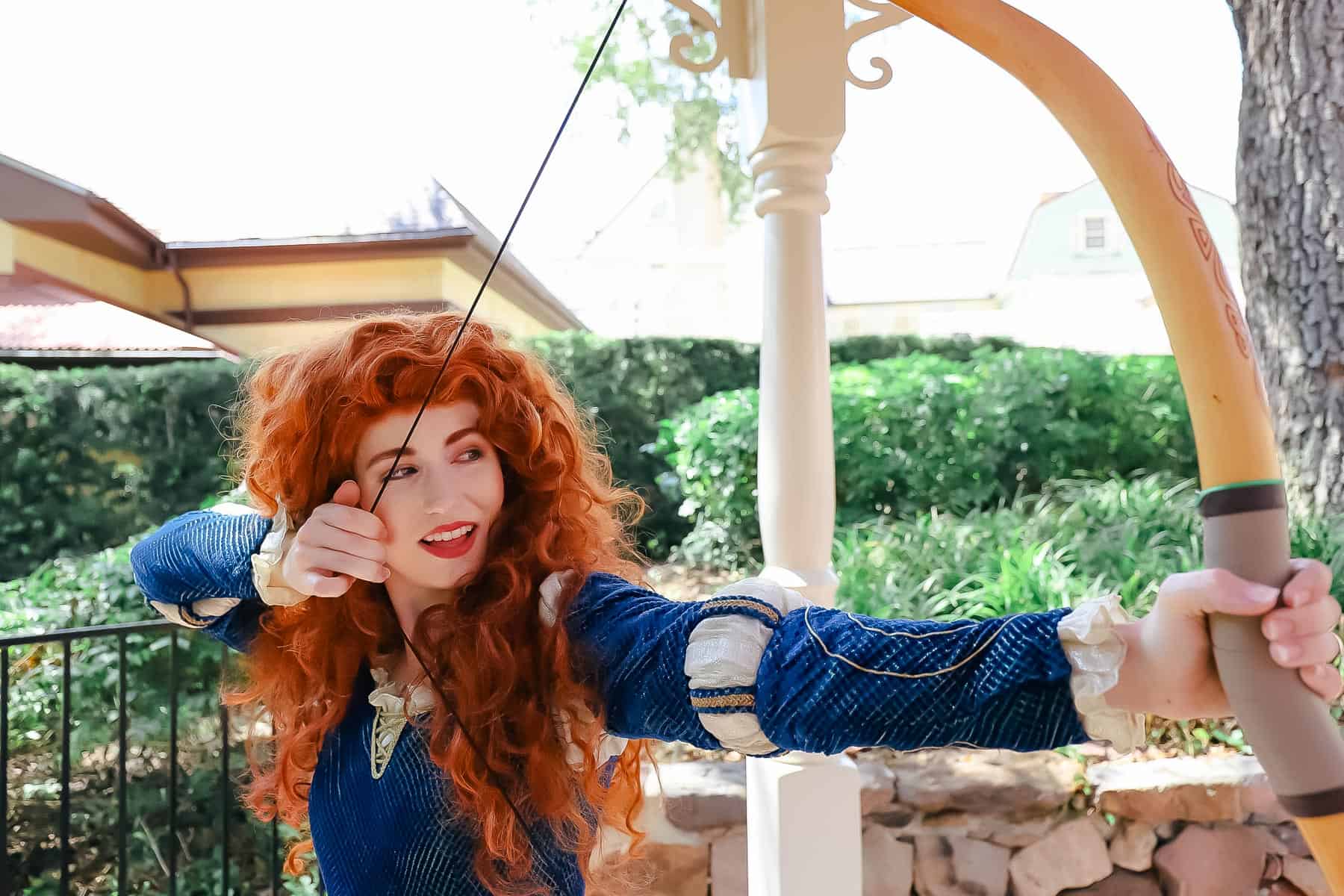 Merida with her bow string pulled.