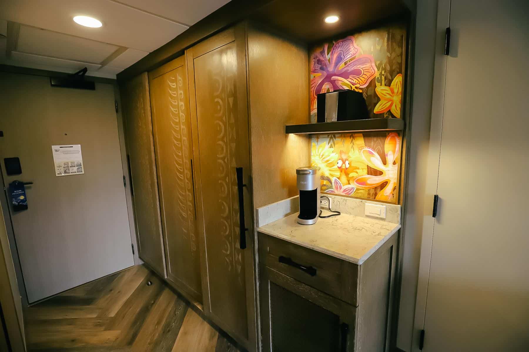 Amenity area includes shelves and artwork backdrop featuring Hei Hei from Moana. 