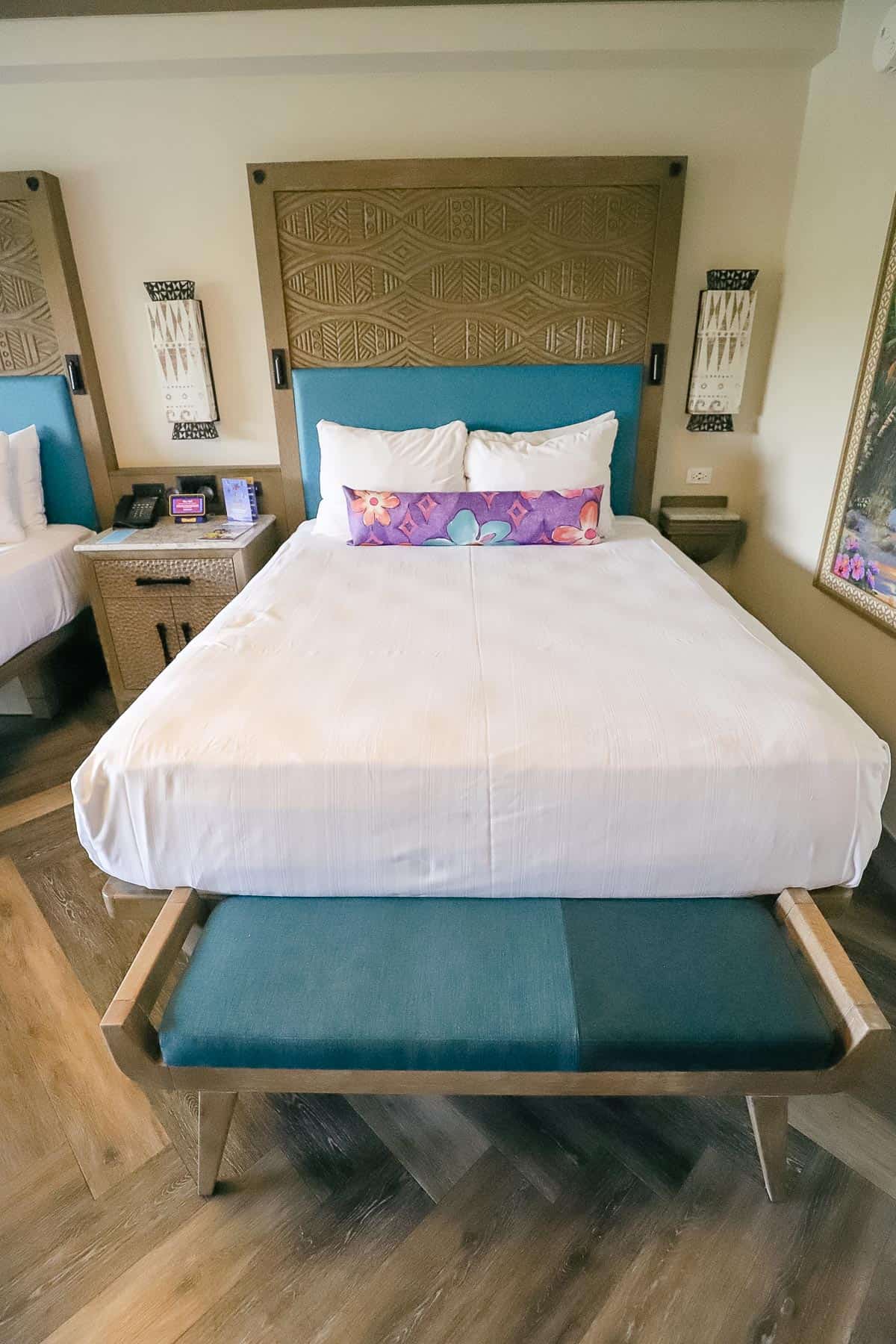 queen size bed with Moana elements and a tropical purple pillow
